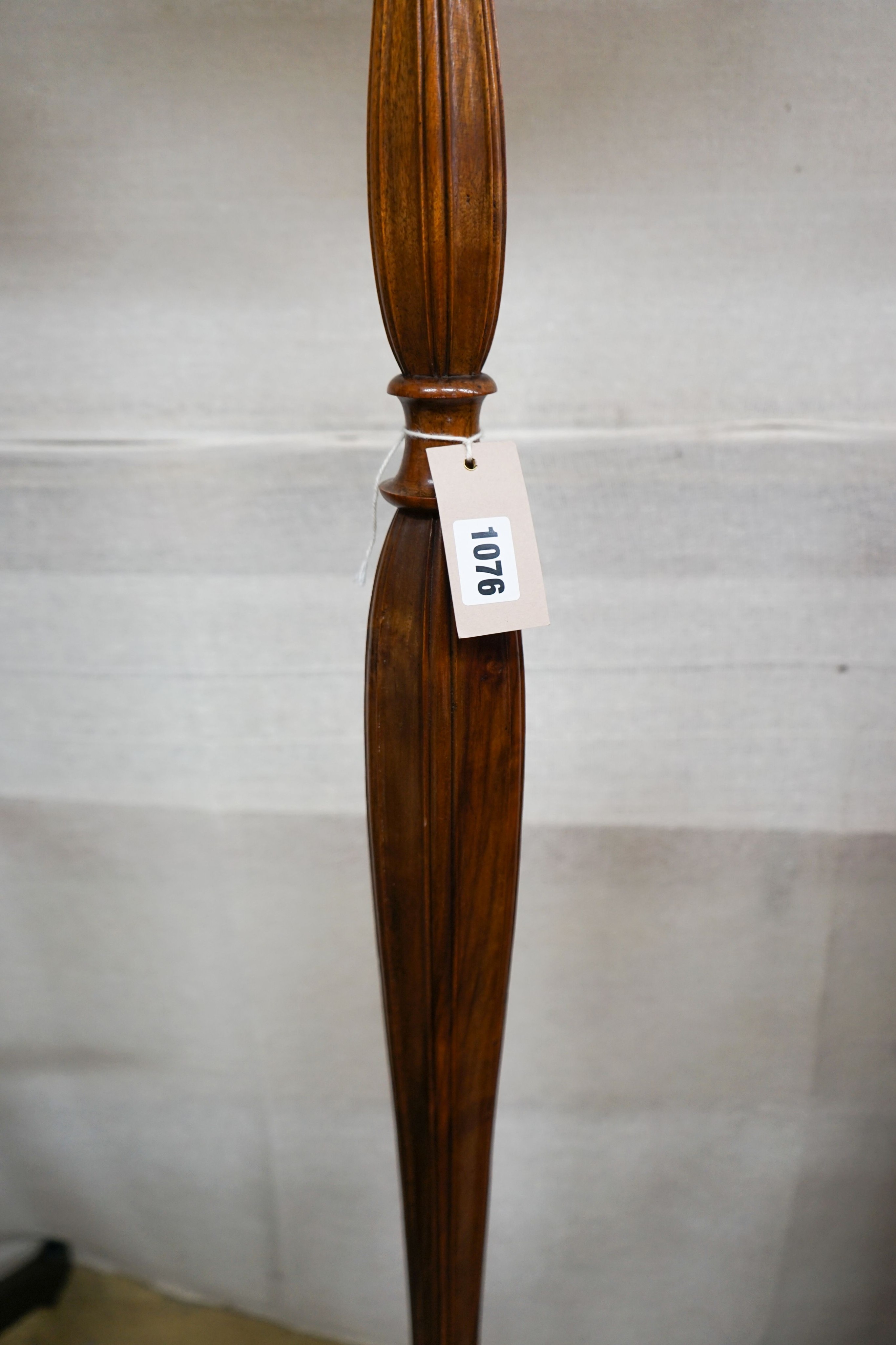 A turned and carved walnut standard lamp on circular base with bun feet, height excluding shade 132cm